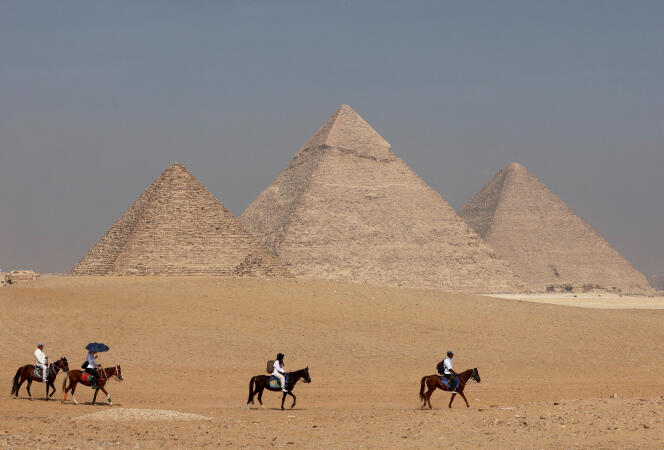 Tourists on horseback in front of the Great Pyramid of Giza, near Cairo, October 26, 2023. 