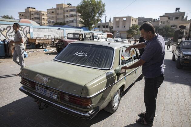 A Palestinian driver uses cooking oil as an alternative fuel in Khan Younes, southern Gaza Strip, October 30, 2023.
