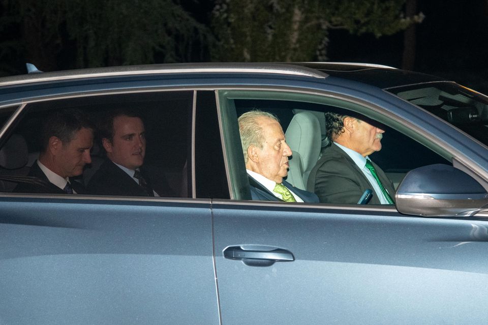 Juan Carlos heads to the airport after a quick visit to his granddaughter's birthday party.