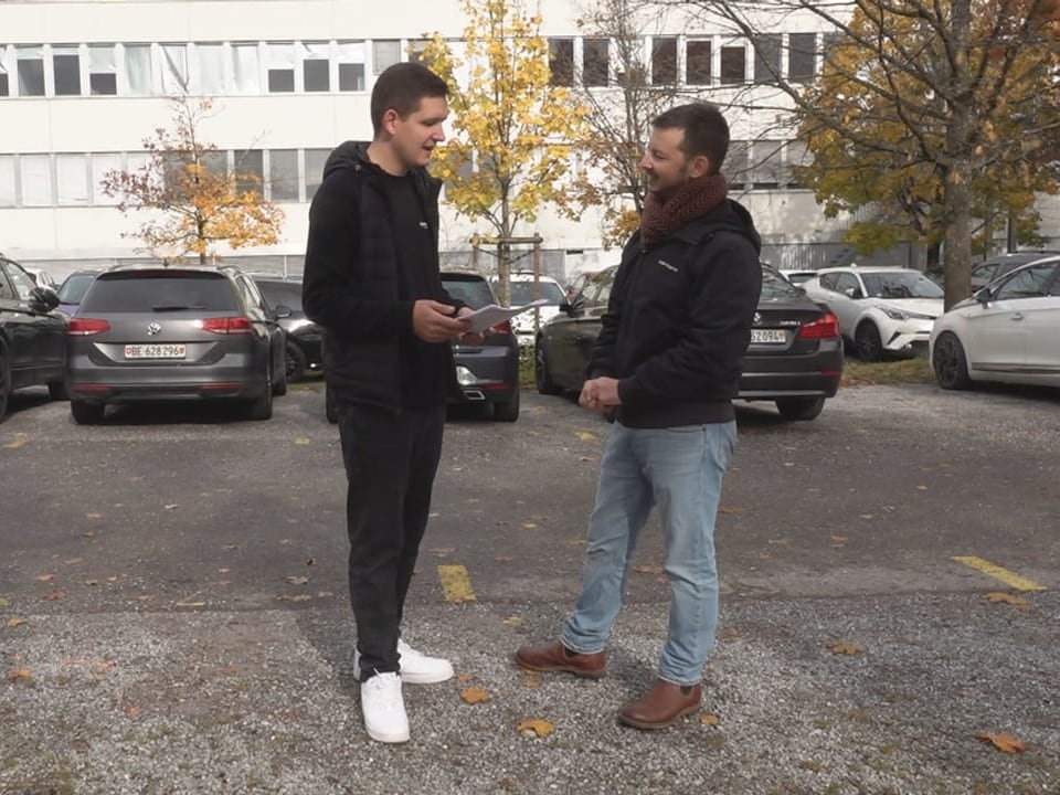 Two men discussing in parking lot