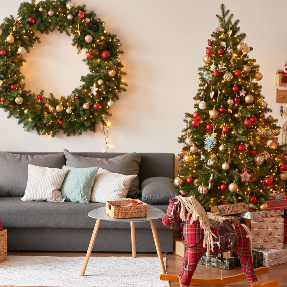 Living room decorated for Christmas with a tree: Those who decorate early for Christmas are happier