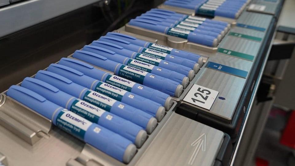 Pens with the drug Ozempic are on display in a production hall.