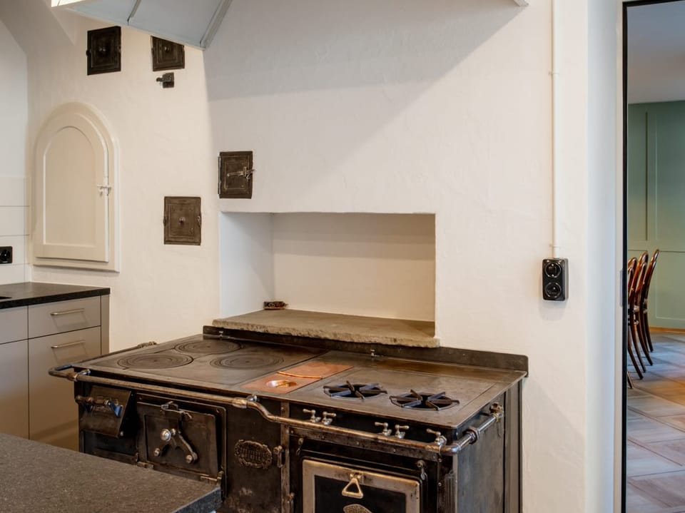 Old oven in a kitchen, modern kitchen furniture in the background