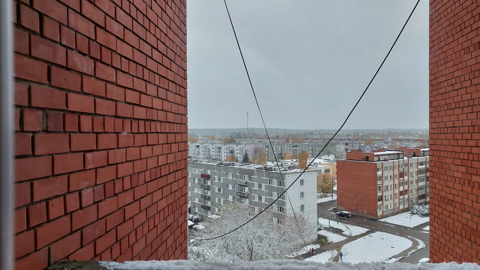 View of the settlement from a prefabricated house with red bricks. 