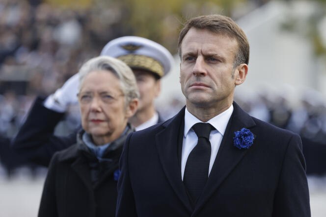President Emmanuel Macron, with Prime Minister Elisabeth Borne, participate in a ceremony commemorating November 11, in Paris.