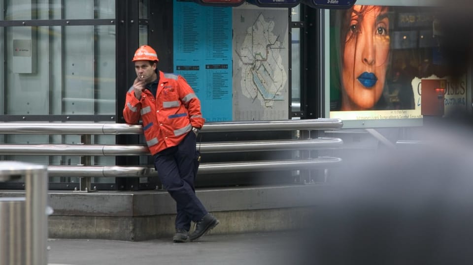 A construction worker taking a smoke break