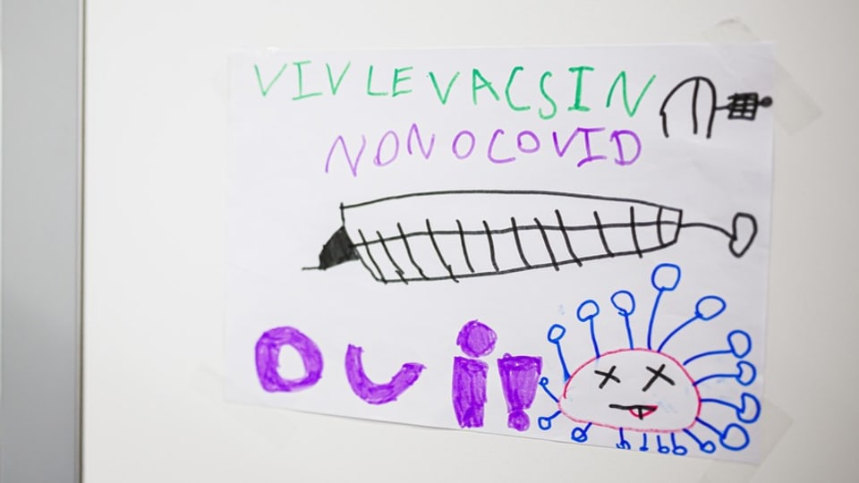 A child's drawing showing a syringe and a 