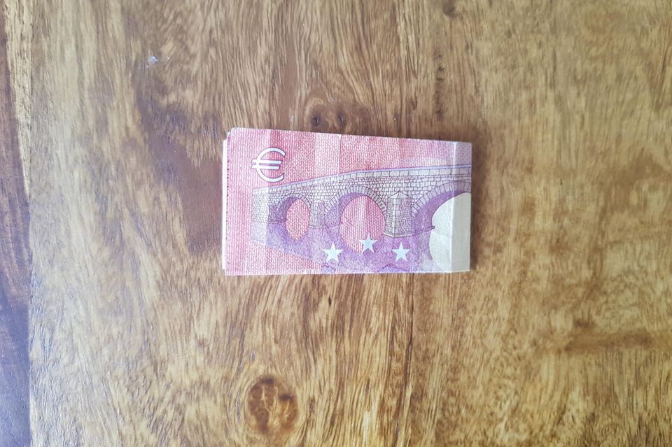 Fold banknotes into a heart: ten euro bill folded in half