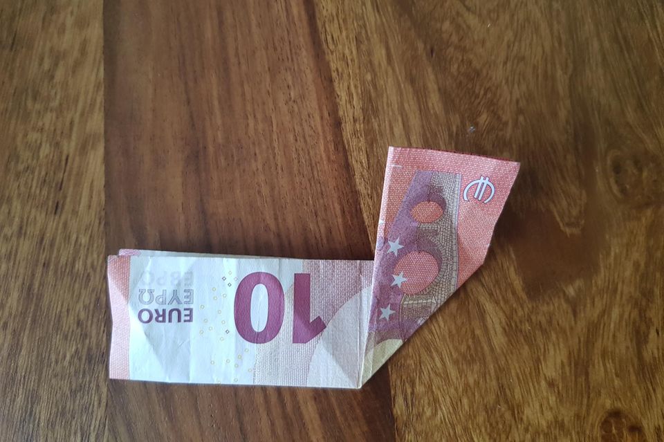 Fold banknotes into a heart: ten euro bill folded