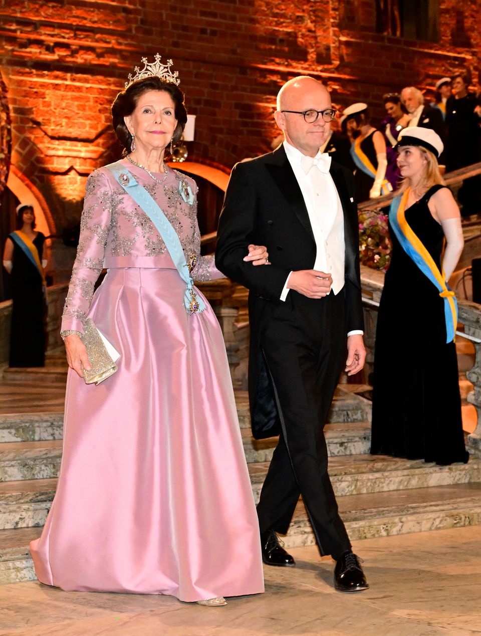 Queen Silvia has a lot of sparkles going on.  Tiara meets glitter clutch and rhinestone decoration. 
