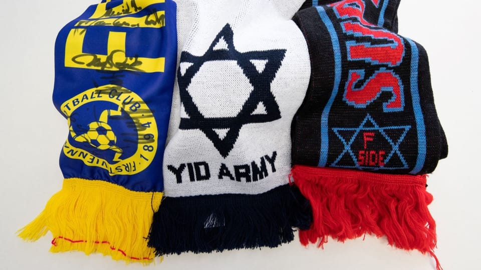Three football fan scarves.  There is a Star of David on a scarf