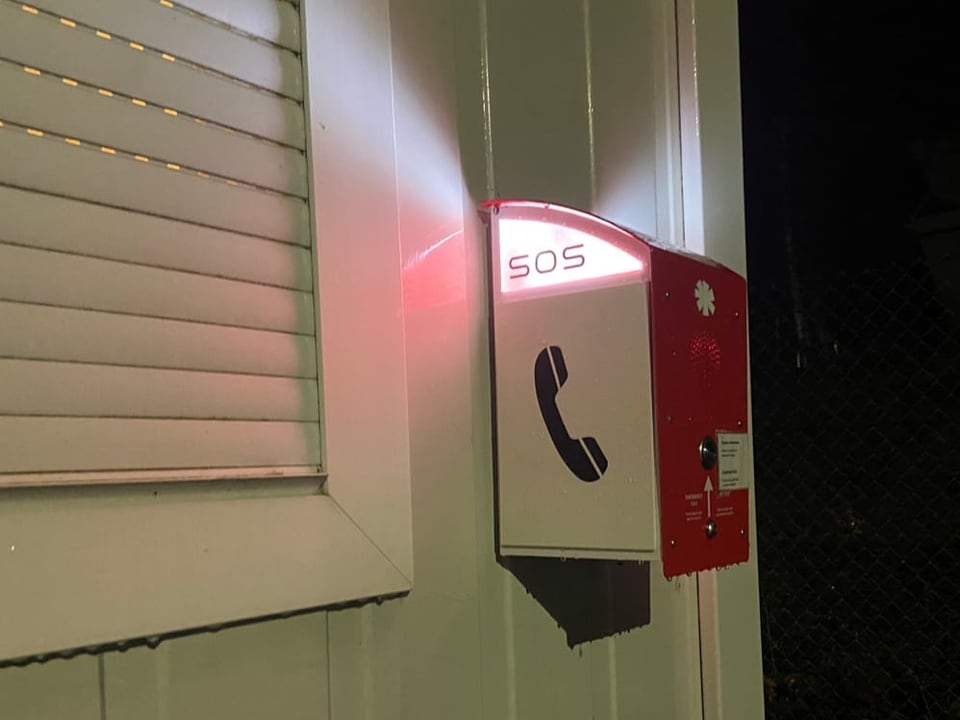 Red SOS box on container building