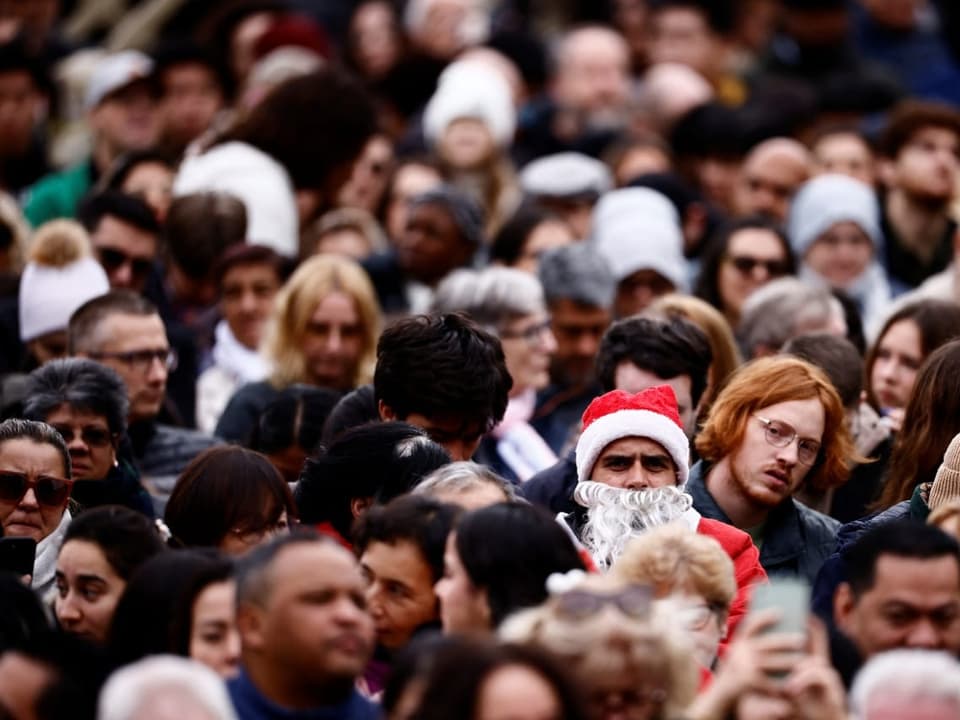People wait for the Pope's speech in St. Peter's Square in the Vatican.