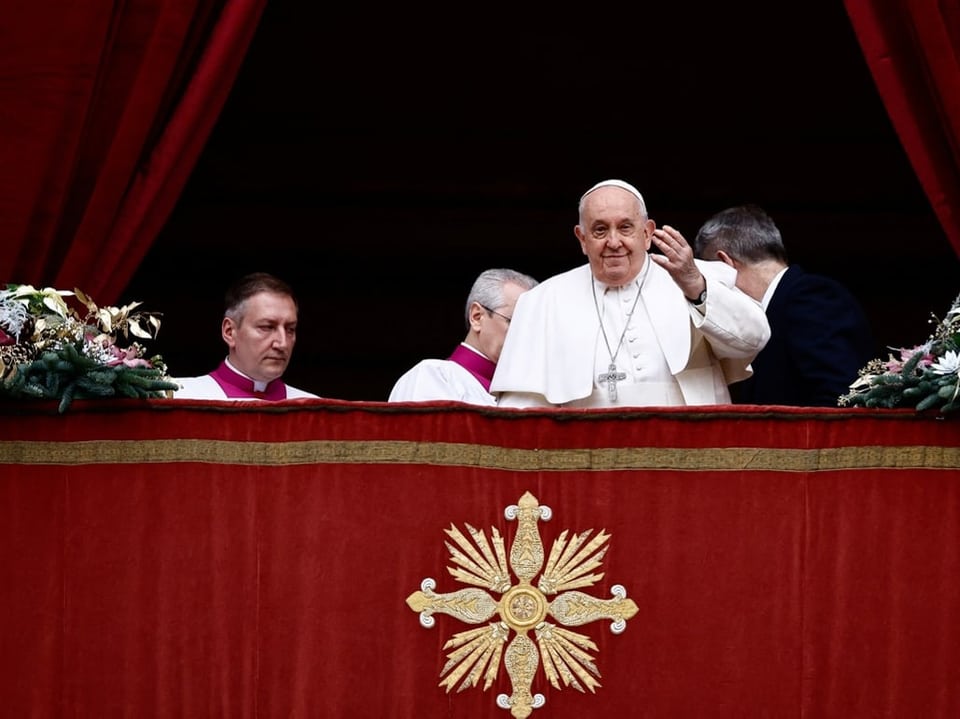 Pope Francis waves from the balcony in St. Peter's Square in Rome.