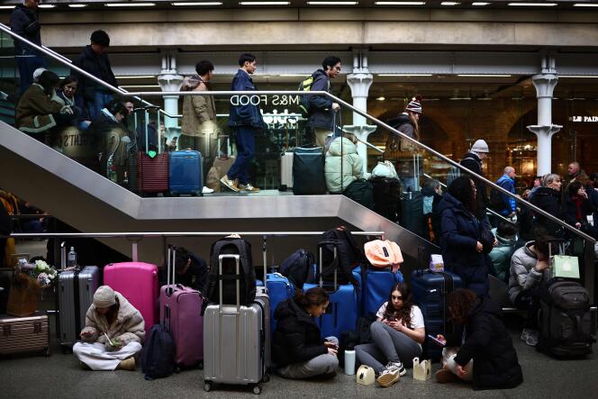 Passengers wait for news of Eurostar departures at St Pancras station in London, as services are disrupted due to flooding, December 30, 2023.