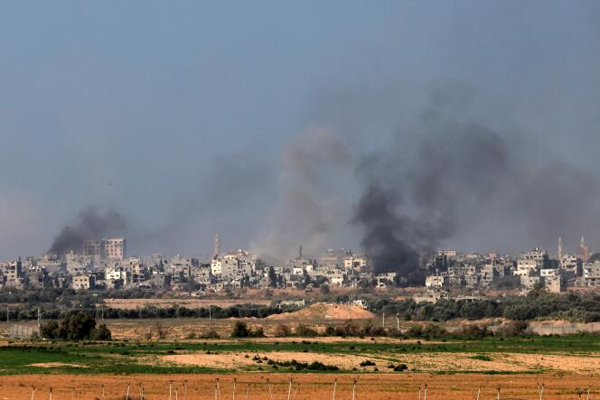 On the Israeli border with the Gaza Strip, smoke rises above the center of Gaza after Israeli strikes, December 31, 2023.