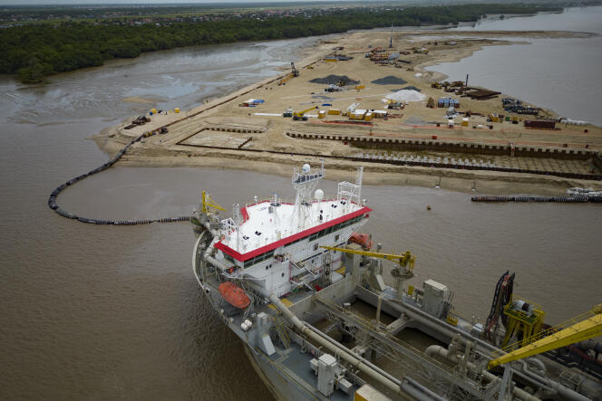 A ship helps create a coastal port needed for offshore oil production at the mouth of the Demerara River in Georgetown, the capital of Guyana, April 11, 2023. 