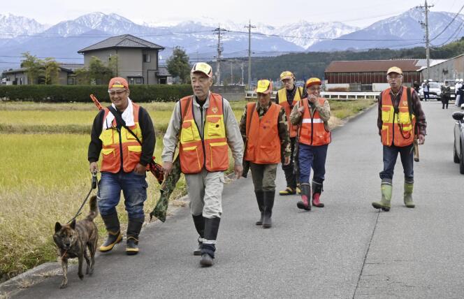 A group of hunters patrol after a bear attack in Toyama, Japan, November 16, 2023.