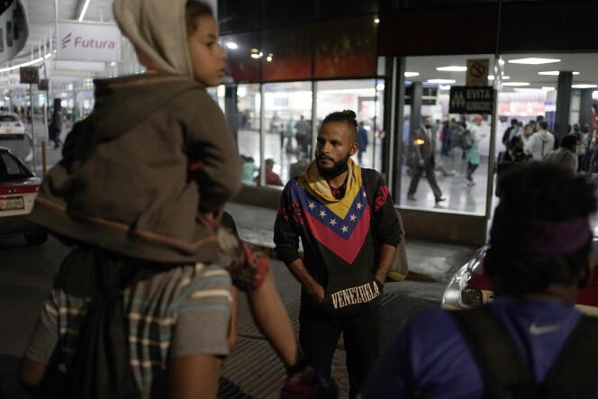 Venezuelan migrants wait for a northbound bus at the northern bus station in Mexico City on October 13, 2022.