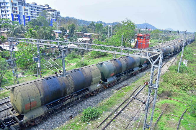 An oil train passes near the Guwahati refinery (Assam, India), operated by Indian Oil Corporation, on March 30, 2023.