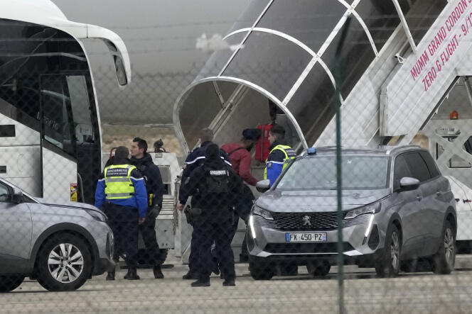 Men board the plane blocked by the police at Vatry airport (Marne), December 25, 2023. 