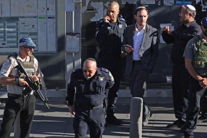 Itamar Ben Gvir (second from right), Israeli Minister of National Security, at the scene of an attack that left three dead and several injured near a bus stop in West Jerusalem, November 30, 2023. 