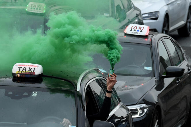 Dozens of taxis protest against rising fuel prices as they travel from Roissy - Charles-de-Gaulle international airport to Bercy, Paris, March 30, 2022.
