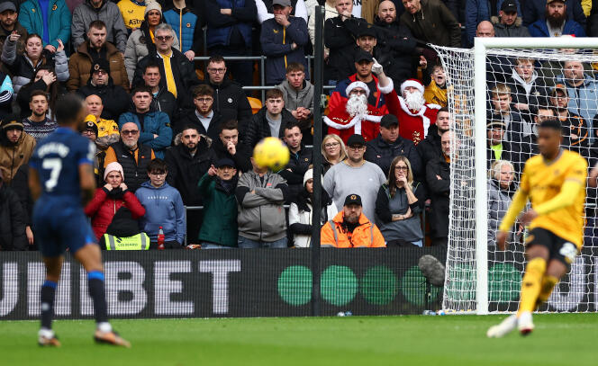Wolverhampton supporters dressed as Santas during Wolves' match against Chelsea, December 24, 2023 in Wolverhampton