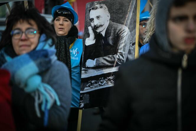 Employees of the Casino group parade with a portrait of Geoffroy Guichard, at the call of the inter-union, in Saint-Etienne, December 17, 2023. 