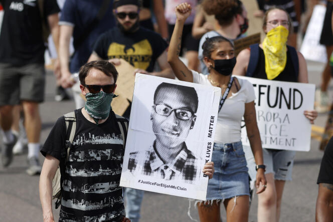 A protester with a photo of Elijah McClain, in Aurora, Colorado, June 27, 2020.