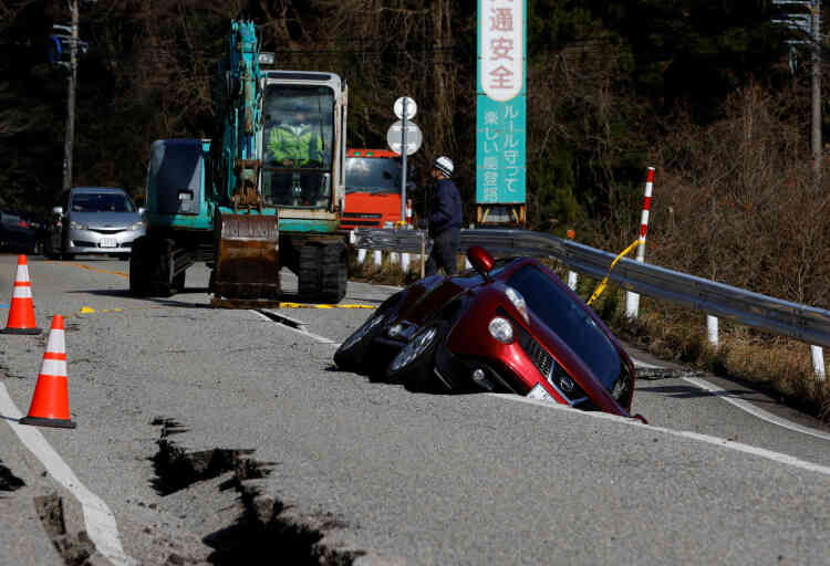 View of a car stuck in a road crack near Ujima, Ishikawa Prefecture, Japan, January 2, 2024.