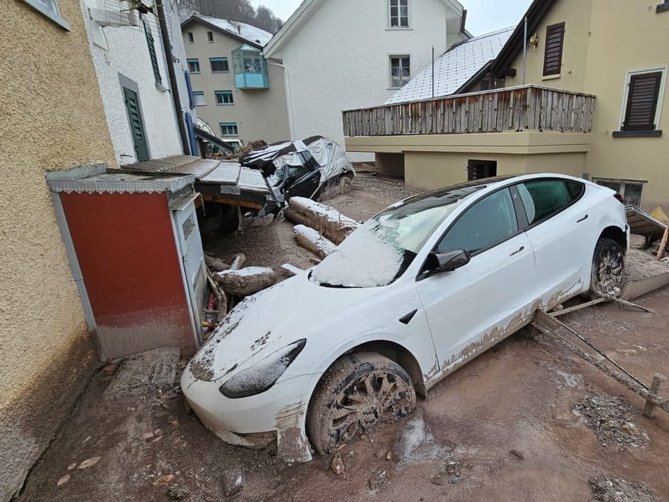 View of two buried cars in the mud of Schwanden (GL).