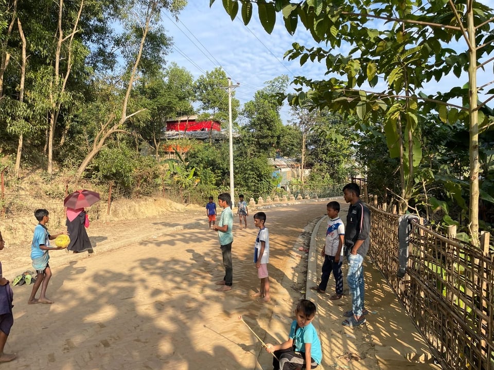 Children play on a non-concrete street.