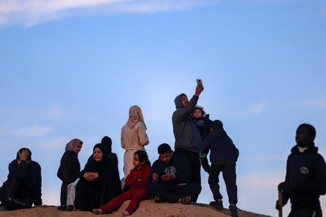 Palestinians use eSIM cards to try to get a signal to contact their loved ones on a hill in Rafah, in the southern Gaza Strip, January 19, 2024.