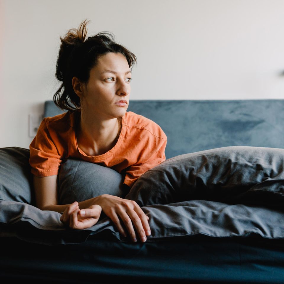 Rest type: woman sitting in bed tired