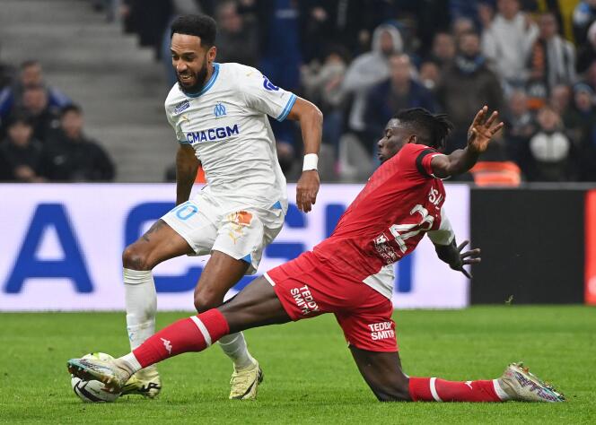 Marseillais Pierre-Emerick Aubameyang (white jersey) tackled by Monegasque Mohammed Salisu, at the Stade Vélodrome, in Marseille, January 27, 2024.