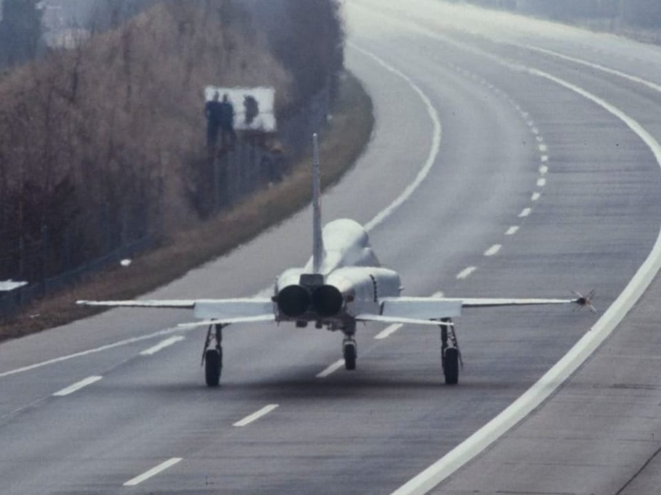 Fighter jet rolls over the highway