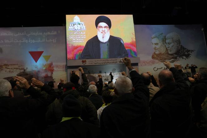 People watch Hezbollah leader Hassan Nasrallah's speech in a southern Beirut suburb on January 3, 2024.