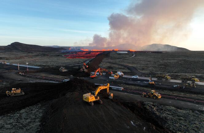 Emergency personnel build a protective wall to prevent lava from reaching the center of the town, after a volcanic eruption, in Grindavik, southwest Iceland, January 14, 2024. 
