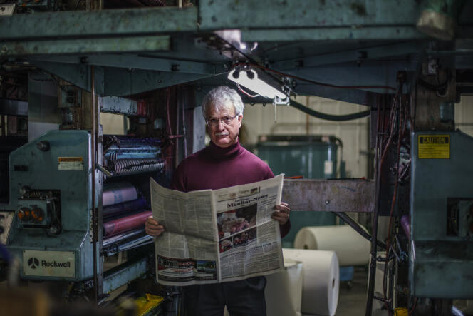 Reed Anfinson, managing editor of the Swift County Monitor-News, with a copy of the last edition of his newspaper before its final shutdown, in Lowry, Minnesota, in November 2021. 