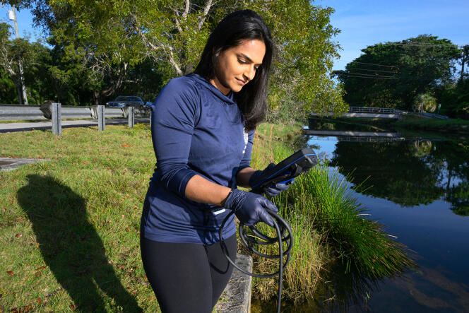 Biologist Aliza Karim takes water samples from a canal in Miami, Florida, looking for indicators of fecal contamination.