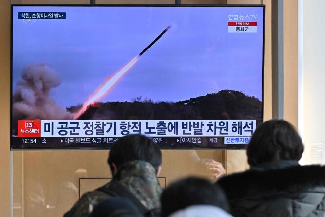 People watch a television screen broadcasting a news bulletin with images of a North Korean missile test in the Yellow Sea, at a train station in Seoul, January 24, 2024. 