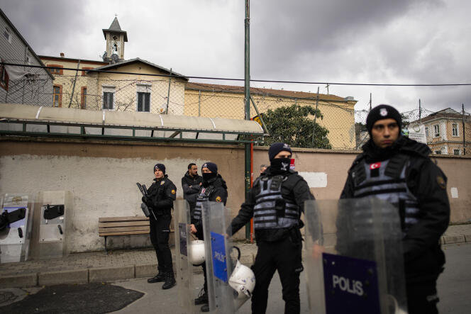 Turkish police officers stand guard in a cordoned off area outside Santa Maria Church, Istanbul, Sunday January 28, 2024.