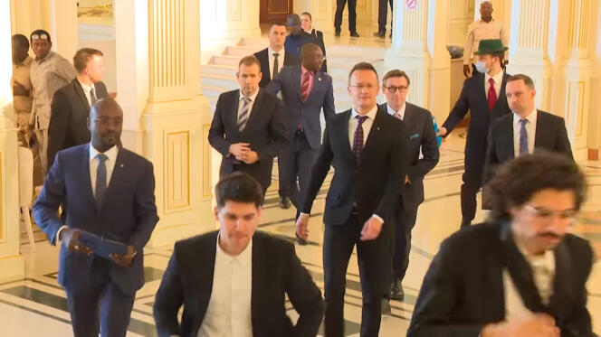 Screenshot of a video broadcast on December 7, 2023 on the Facebook account of the Presidency of the Republic of Chad showing the head of Hungarian diplomacy received by the Chadian head of state.  Gaspar Orban is in the background on the right, with a green hat.