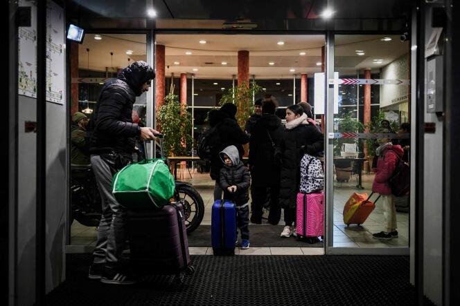 Families leave a hotel where they were staying, in Lyon, on January 8, 2024.