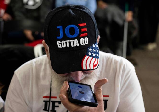 A supporter of Donald Trump wears a cap embroidered with “Joe must go” during a rally of the former US president in Newton, Iowa, January 6, 2024. 