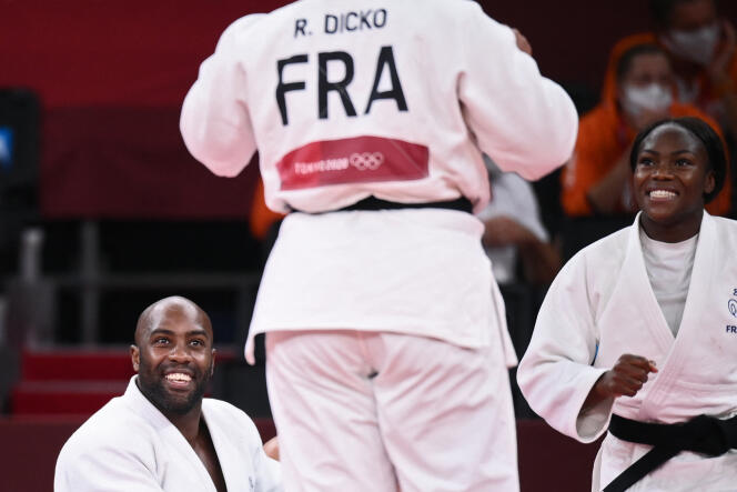 Teddy Riner and Clarisse Agbegnenou congratulate Romane Dicko (from behind) after she won the deciding point in the mixed judo team's B semi-final against the Netherlands, during the Tokyo 2020 Olympic Games, Nippon Tokyo Budokan, July 31, 2021.