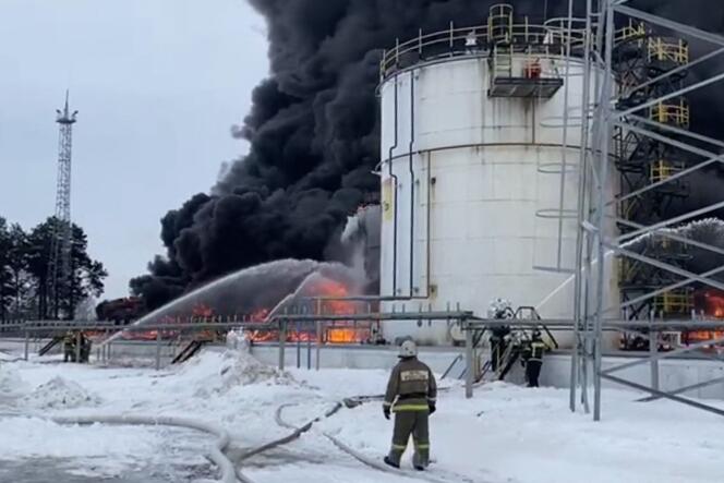 This video capture from footage released by the Russian Emergencies Ministry on January 19, 2024, shows rescuers working to extinguish a fire at an oil depot following a drone attack in Klintsy, Bryansk region . 