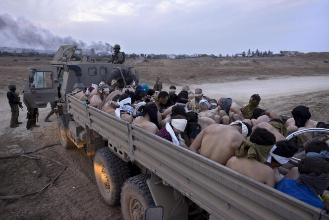 An Israeli truck loaded with bound and blindfolded Palestinian detainees, in Gaza, December 8, 2023.