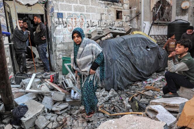 Palestinians inspect an apartment destroyed by Israeli bombardment on Rafah, in the southern Gaza Strip, February 8, 2024.